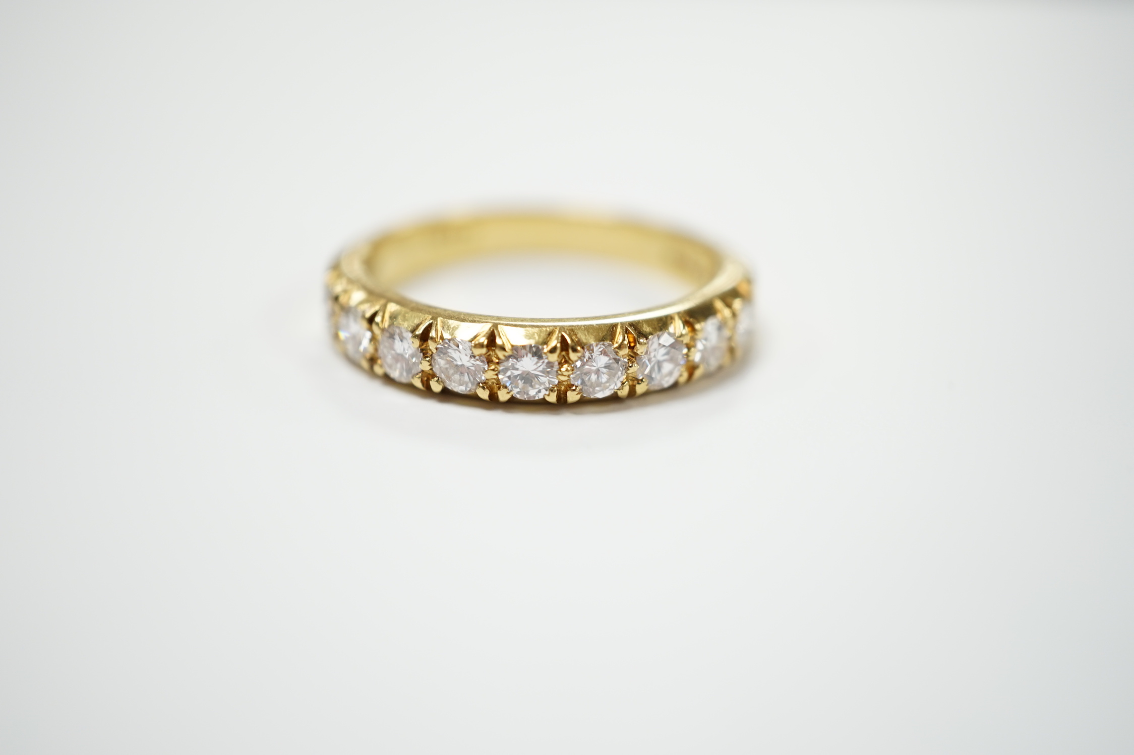 A modern 18ct gold and nine stone diamond set half hoop ring, size R/S, gross weight 6 grams.